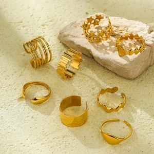 8-piece set of 18k gold plated geometric irregular stainless steel rings on a stone base