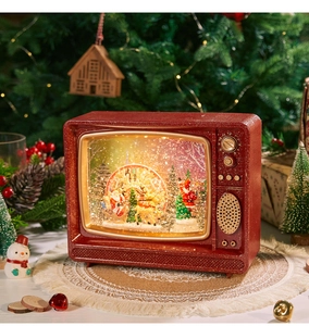 Vintage red TV music box with Santa Claus and glitter sequins in a festive setting
