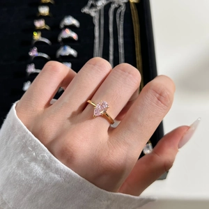 Close-up of pink pear-cut zircon ring in gold-plated sterling silver on model's hand