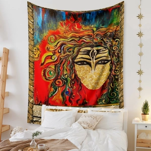 Detail view of Bohemian tapestry with colorful abstract face art hanging in a cozy bedroom