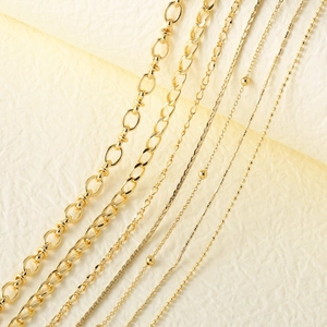 Collection of gold plated DIY jewelry chains including figaro and snake styles