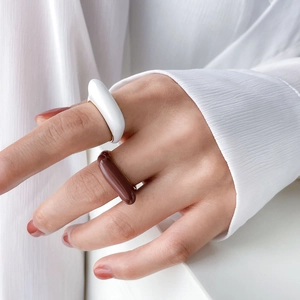 Minimalist geometric enamel checkered rings in white and coffee brown with gold inner trim