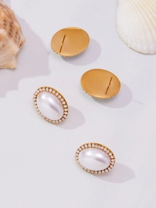 Macro detail of oval pearl stud earrings with zircon halo and gold plating showing both sides