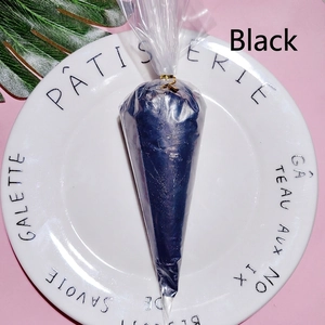 Macro shot of 100g black pearlescent cream glue in cone bag for DIY crafts and phone cases