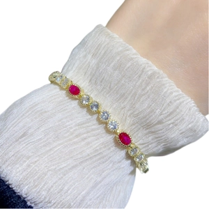 Luxurious gold-plated bracelet with oval red rubies and sparkling white zircons for women