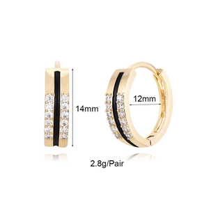 Detail of 14mm gold hoop earrings with black enamel stripes and sparkling cubic zirconia