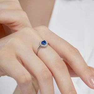 Elegant S925 sterling silver ring featuring a blue heart gemstone and halo of zircons