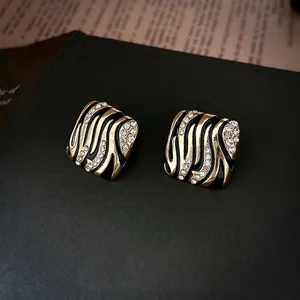 Vintage rhombus stud earrings with zebra print and rhinestones in black and gold