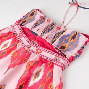 Detail of ethnic geometric print dress with halter neck and elastic back smocking