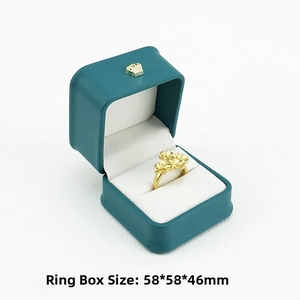Teal PU leather ring box featuring a gold crown emblem and flower ring inside
