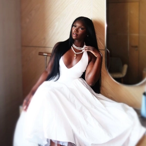 Elegant white halter neck dress with deep V-neck and multi-layer pearl necklace charm