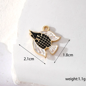 Macro view of a black and white enamel tropical fish pendant with 2.1cm x 1.8cm dimensions