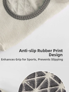 Close-up of non-slip silicone grippers on the sole of gray cotton yoga socks