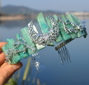 Detail of bohemian crown with raw green crystal stones and silver moon branch accents