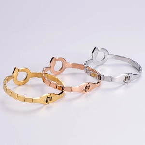 Three wrench-shaped titanium steel bracelets in gold, silver, and rose gold finishes