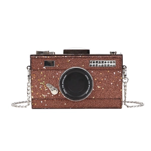 Sparkly camera-shaped crossbody bag with bronze sequins and a metallic chain strap