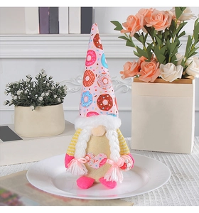 Detail of a Christmas gnome featuring a donut-patterned hat and braided hair on a plate