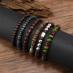 Detail of 6-piece bohemian wooden and metal beaded bracelet set on a display stand