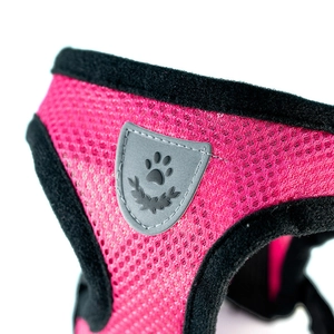 Close-up of breathable rose red mesh pet harness with black trim and shield logo detail