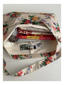 Top view of large capacity floral canvas tote bag showing interior space for laptop and books