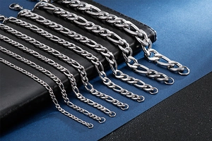 Polished titanium steel NK Figaro chains showing various thicknesses on leather