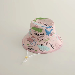 Detail of pink cotton sun hat with colorful dinosaur prints and white adjustable chin strap