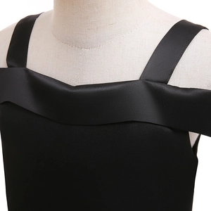 Detail of the black satin neckline and shoulder straps on a girl Halloween witch dress