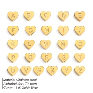 Macro view of 7x6mm stainless steel heart alphabet beads with A-Z engraving