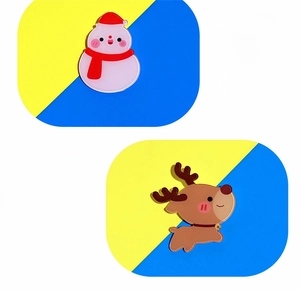 Detail of cute acrylic Christmas pins featuring cartoon snowman and reindeer patterns