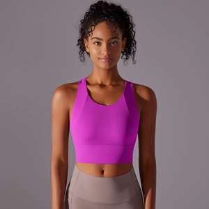 Detail of fuchsia sports bra featuring seamless construction and elastic wide underband support