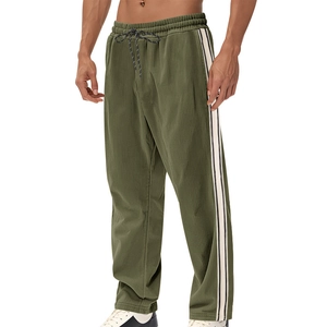Close-up of olive green corduroy pants with side stripes and adjustable drawstring