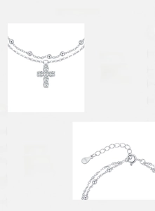 Macro detail of S925 sterling silver stamp and double-layered cross pendant with zircons