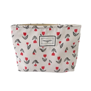 Corduroy makeup bag with red tulip floral pattern and Time to Party label
