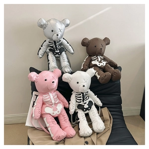 Detail view of four cute bear backpacks with gothic skull patterns in various colors