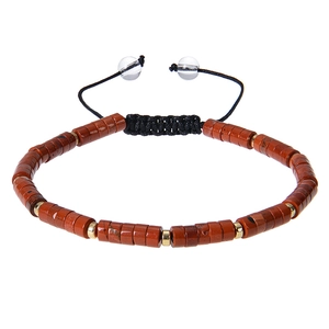 Macro detail of red jasper cylinder beads and golden metal spacers on woven bracelet