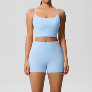Close-up of light blue yoga set featuring a thin strap sports bra and high waist shorts