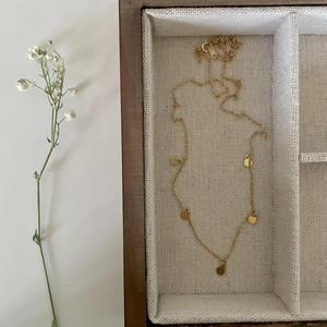 Elegant 925 sterling silver gold necklace with five circular discs in a wooden jewelry box