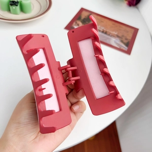 Red square hair claw clip for women, stylish large shark hair clip for thick hair styling.