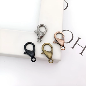 Close-up of alloy lobster clasps in gun black, black, bronze, and copper for DIY jewelry