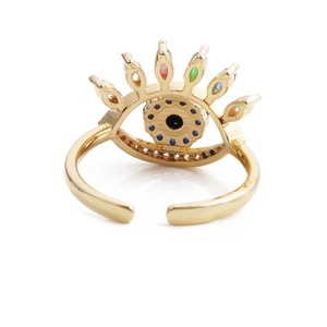 Macro detail of golden evil eye open ring with multicolored zircon stones inlay