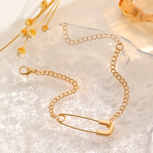 Detail of a gold paperclip link bracelet with adjustable chain and lobster clasp closure