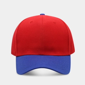 Detail of a six-panel baseball cap showing red crown and blue brim contrast stitching