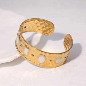 18K gold plated wide cuff bracelet with white enamel inlay and hammered texture details