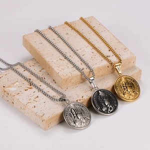 Three praying hands medallion necklaces in gold, silver, and vintage silver finishes