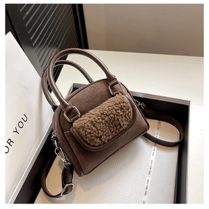 Brown faux suede handbag with khaki faux fur front pocket detail on a stylish gift box