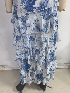 Detail of elegant tiered blue and white floral chiffon ruffles on a strapless evening gown