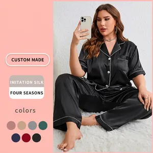 Women's two-piece black imitation silk pajama set with white piping and short sleeve top