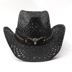 Detail of black woven cowboy hat featuring leather band and silver bull head ornament