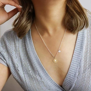 18K gold sunflower necklace with zircon inlay and engraved heart tag worn by model