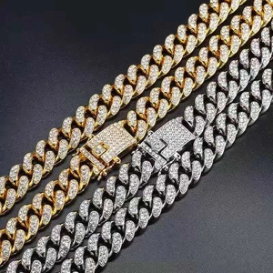 Detailed close-up of iced-out Cuban link chains with crystal-encrusted box clasps